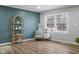 Stylish living room with modern decor, new wood flooring and an accent wall at 3407 Allison Ave, Indianapolis, IN 46224