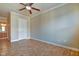 Bedroom featuring hardwood floors, a ceiling fan, and en-suite bath access at 355 E Ohio St # 310, Indianapolis, IN 46204