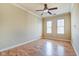 Spacious bedroom featuring hardwood floors, a ceiling fan, and two windows at 355 E Ohio St # 310, Indianapolis, IN 46204