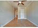 Bedroom with hardwood floors, ceiling fan, and access to adjacent rooms at 355 E Ohio St # 310, Indianapolis, IN 46204