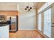 Bright dining area features hardwood floors, modern light fixture and access to the exterior at 355 E Ohio St # 310, Indianapolis, IN 46204