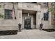 Building entrance featuring stone facade, decorative doors, and flagpoles at 355 E Ohio St # 310, Indianapolis, IN 46204