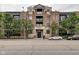 Brick building facade with stylish architecture, balconies, and manicured trees at 355 E Ohio St # 310, Indianapolis, IN 46204