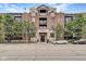 Brick building facade with stylish architecture, balconies, and manicured trees at 355 E Ohio St # 310, Indianapolis, IN 46204