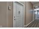 Hallway featuring a white door with decorative hardware and carpeted floors at 355 E Ohio St # 310, Indianapolis, IN 46204