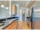 Modern kitchen with stainless appliances and an opening into the adjacent bathroom at 355 E Ohio St # 310, Indianapolis, IN 46204