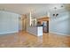 Open-concept kitchen with stainless steel appliances, island, and hardwood floors at 355 E Ohio St # 310, Indianapolis, IN 46204