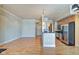 Kitchen with stainless steel appliances, breakfast bar, and hardwood floors at 355 E Ohio St # 310, Indianapolis, IN 46204