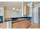 Kitchen area with stainless appliances, granite countertops, and wood cabinets at 355 E Ohio St # 310, Indianapolis, IN 46204