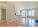 Open concept living room with hardwood floors flowing into kitchen area at 355 E Ohio St # 310, Indianapolis, IN 46204