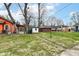 Spacious backyard with a mix of green grass and chain link fencing, offering privacy at 3559 Carrollton Ave, Indianapolis, IN 46205