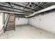 Unfinished basement with concrete floor and utility access, ready for customization at 3559 Carrollton Ave, Indianapolis, IN 46205