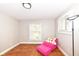 Bright bedroom features hardwood floors, fresh paint, and natural light from two windows at 3559 Carrollton Ave, Indianapolis, IN 46205