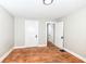 Bedroom features hardwood floors and neutral paint, enhanced by white baseboards and doors at 3559 Carrollton Ave, Indianapolis, IN 46205