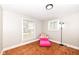 Bedroom features natural light from two windows, with refinished hardwood floors at 3559 Carrollton Ave, Indianapolis, IN 46205