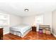 Cozy bedroom with hardwood floors, natural light, and ample space for relaxation and rest at 3559 Carrollton Ave, Indianapolis, IN 46205
