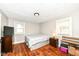 Bedroom features wood floors, closet, two windows, and a ceiling mounted light fixture at 3559 Carrollton Ave, Indianapolis, IN 46205