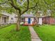 A lovely home featuring a vibrant blue door and a cozy wood porch at 3559 Carrollton Ave, Indianapolis, IN 46205
