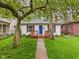 Charming home featuring a vibrant blue front door and a cozy wood porch at 3559 Carrollton Ave, Indianapolis, IN 46205