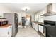 This kitchen has stainless steel appliances, plenty of counter space, and a view into the laundry area at 3559 Carrollton Ave, Indianapolis, IN 46205