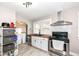 Well-lit kitchen features modern appliances, white cabinetry, and butcher block countertops, offering a stylish and functional space at 3559 Carrollton Ave, Indianapolis, IN 46205