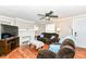 Comfortable living room featuring a decorative fireplace and a ceiling fan at 3559 Carrollton Ave, Indianapolis, IN 46205