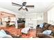 Open concept living room with dining area, fireplace, and TV at 3559 Carrollton Ave, Indianapolis, IN 46205