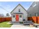 Backyard showcasing a white home with a bright orange door, modern patio, and privacy fence at 358 Terrace Ave, Indianapolis, IN 46225