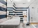 Bathroom featuring striped walls, an updated vanity, and a shower with tub combination at 358 Terrace Ave, Indianapolis, IN 46225