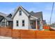 Charming two-story home featuring a well-manicured lawn and inviting front porch, enclosed by a modern fence at 358 Terrace Ave, Indianapolis, IN 46225
