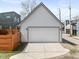 Detached garage with a clean white exterior and a large parking pad at 358 Terrace Ave, Indianapolis, IN 46225