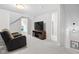Living room featuring two chairs, a large TV, and modern lighting at 358 Terrace Ave, Indianapolis, IN 46225