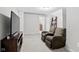 Comfortable living room with two chairs, a large TV, and modern lighting at 358 Terrace Ave, Indianapolis, IN 46225