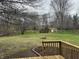 Lush backyard with deck, mature trees, and two storage sheds at 3734 Ontario Cir, Indianapolis, IN 46268