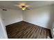 A bedroom is equipped with a ceiling fan, hardwood floors, white painted walls and base molding at 3734 Ontario Cir, Indianapolis, IN 46268