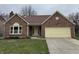 Charming brick home with attached garage and well-maintained lawn at 3734 Ontario Cir, Indianapolis, IN 46268