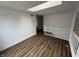 Spacious living room with wood floors, bright skylight, and staircase with white railing at 3734 Ontario Cir, Indianapolis, IN 46268