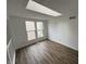 Bright living room featuring a skylight, wood floors, and large windows at 3734 Ontario Cir, Indianapolis, IN 46268