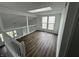 An upstairs living room featuring hardwood floors, a skylight and large windows for plenty of natural light at 3734 Ontario Cir, Indianapolis, IN 46268