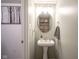Charming powder room featuring a pedestal sink, decorative mirror, and stylish lighting at 4345 Elkhorn Dr, Westfield, IN 46062