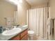 Neutral bathroom featuring a shower with a patterned curtain and a vanity with a gray countertop at 4345 Elkhorn Dr, Westfield, IN 46062