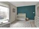 Bedroom featuring an accent wall, window, crib, and changing table at 4345 Elkhorn Dr, Westfield, IN 46062