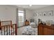 Neutral Bedroom with window, patterned rug, and cribs at 4345 Elkhorn Dr, Westfield, IN 46062