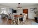 Open-concept dining room features hardwood floors and a wooden table with white chairs at 4345 Elkhorn Dr, Westfield, IN 46062