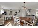 Open-concept dining room adjacent to the kitchen and living room with hard wood floors at 4345 Elkhorn Dr, Westfield, IN 46062
