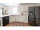 Bright kitchen with white cabinets, sleek countertops, and stainless steel appliances at 4345 Elkhorn Dr, Westfield, IN 46062