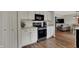 Kitchen features white cabinets, stainless steel appliances and bar stool seating open to the living area at 4345 Elkhorn Dr, Westfield, IN 46062