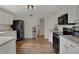 Bright kitchen with white cabinets, black appliances and wood flooring at 4345 Elkhorn Dr, Westfield, IN 46062