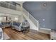 Inviting living room with soaring ceilings, natural light, hardwood floors, and staircase to the second floor at 4345 Elkhorn Dr, Westfield, IN 46062