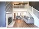 Open-concept living room with fireplace, comfortable seating, and staircase to the upper floor at 4345 Elkhorn Dr, Westfield, IN 46062
